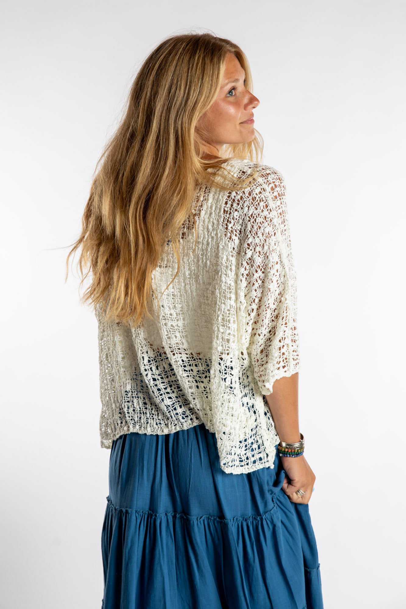 Sophie is wearing the Butterfly Lightweight Poncho in Ivory