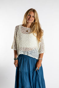 Sophie is wearing the Butterfly Lightweight Poncho in Ivory