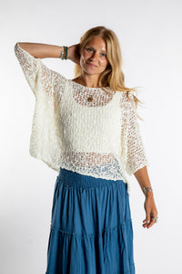 Sophie is wearing the Butterfly Lightweight Poncho in Ivory