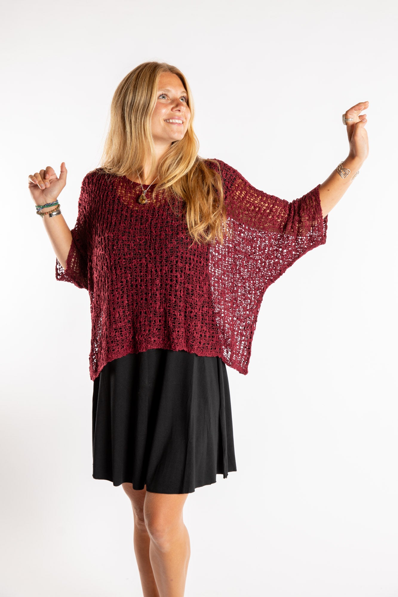Sophie is wearing the Butterfly Lightweight Poncho in Maroon
