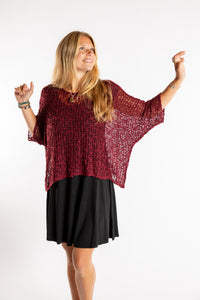 Sophie is wearing the Butterfly Lightweight Poncho in Maroon