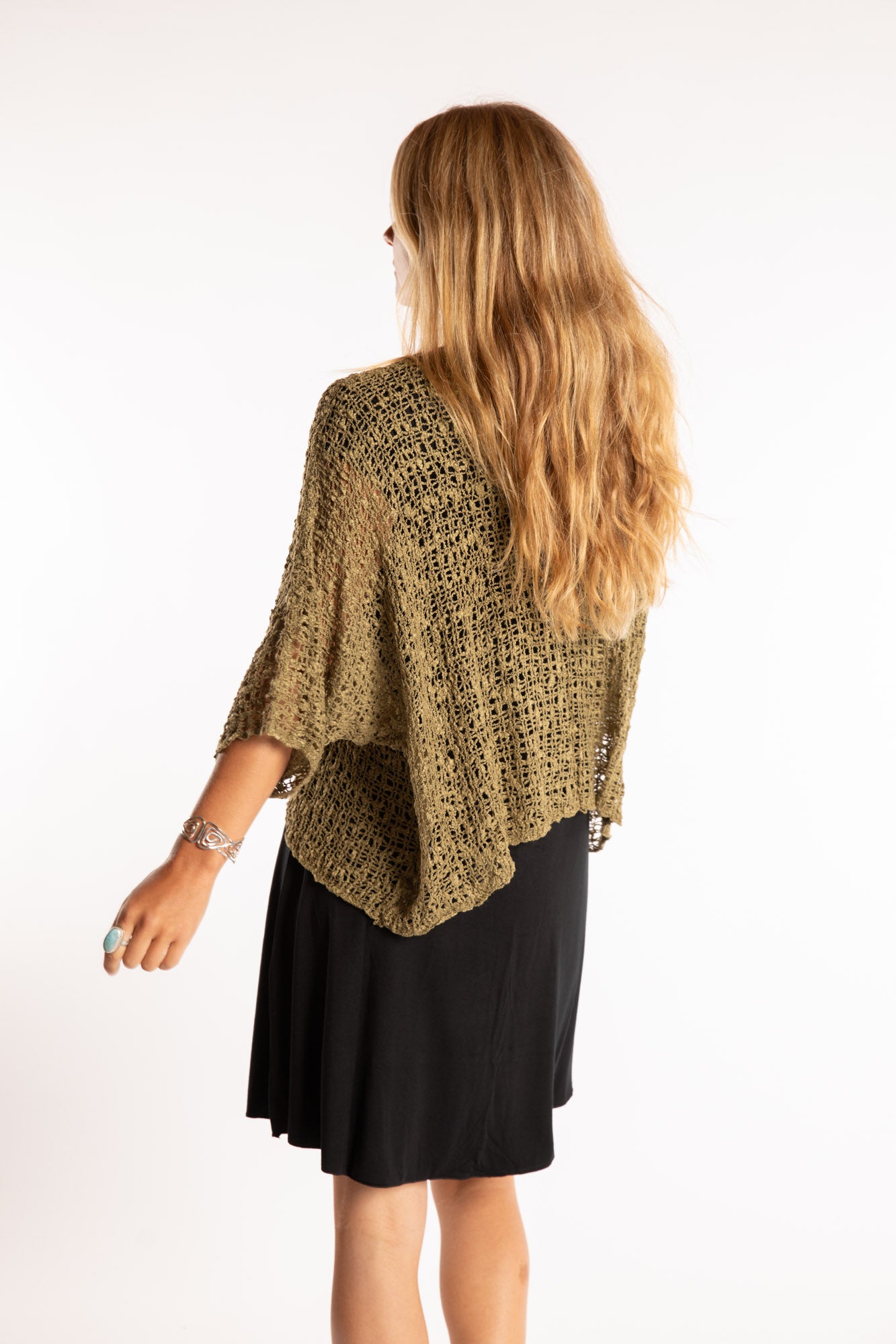 Sophie is wearing the Butterfly Lightweight Poncho in Olive