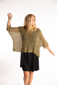 Sophie is wearing the Butterfly Lightweight Poncho in Olive