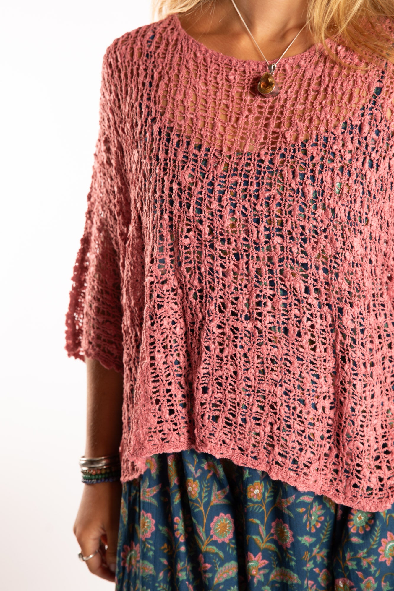 Sophie is wearing the Butterfly Lightweight Poncho in Pink