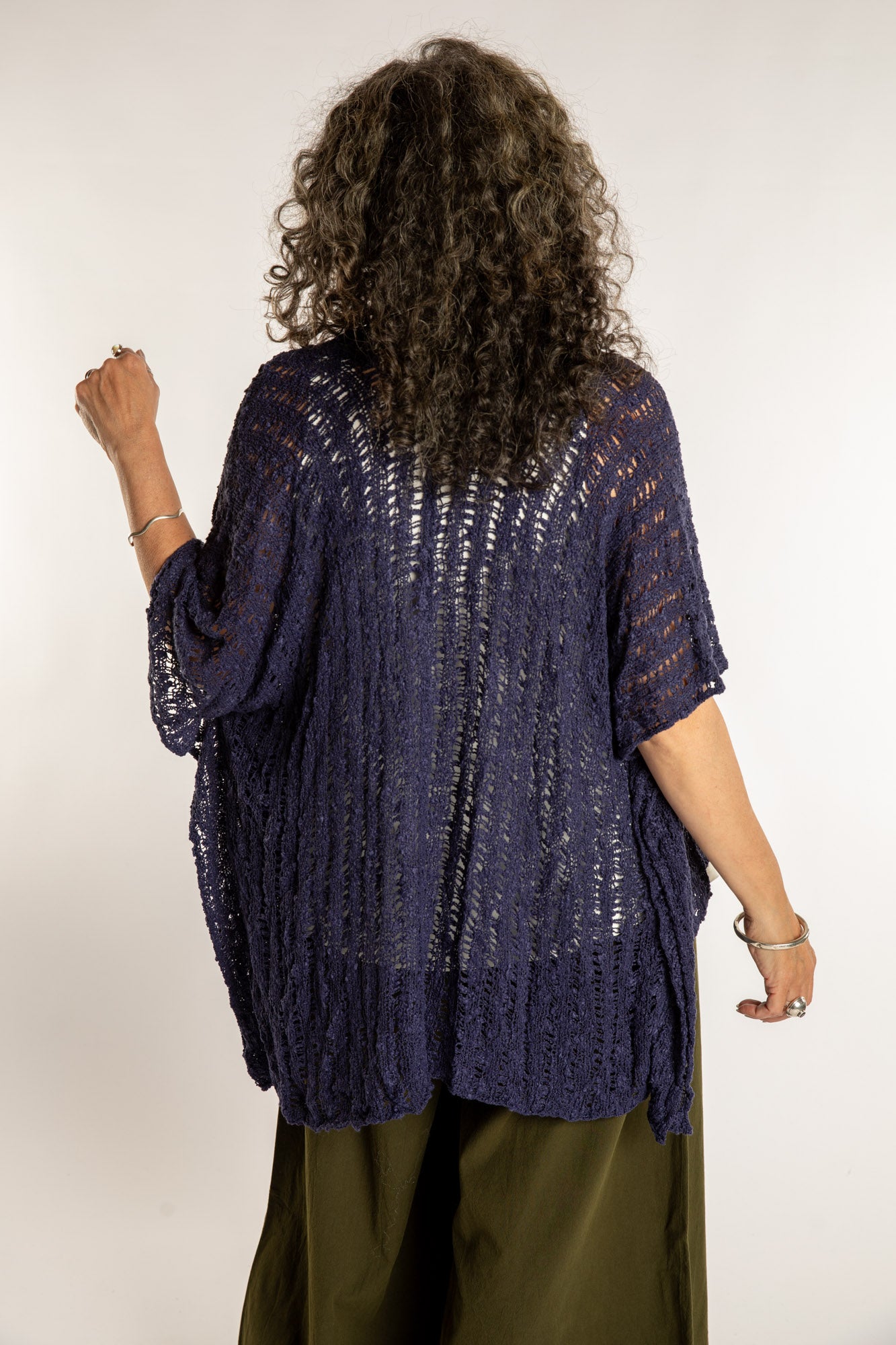 Susan is wear the Cascade Loose Weave Cardigan in Navy