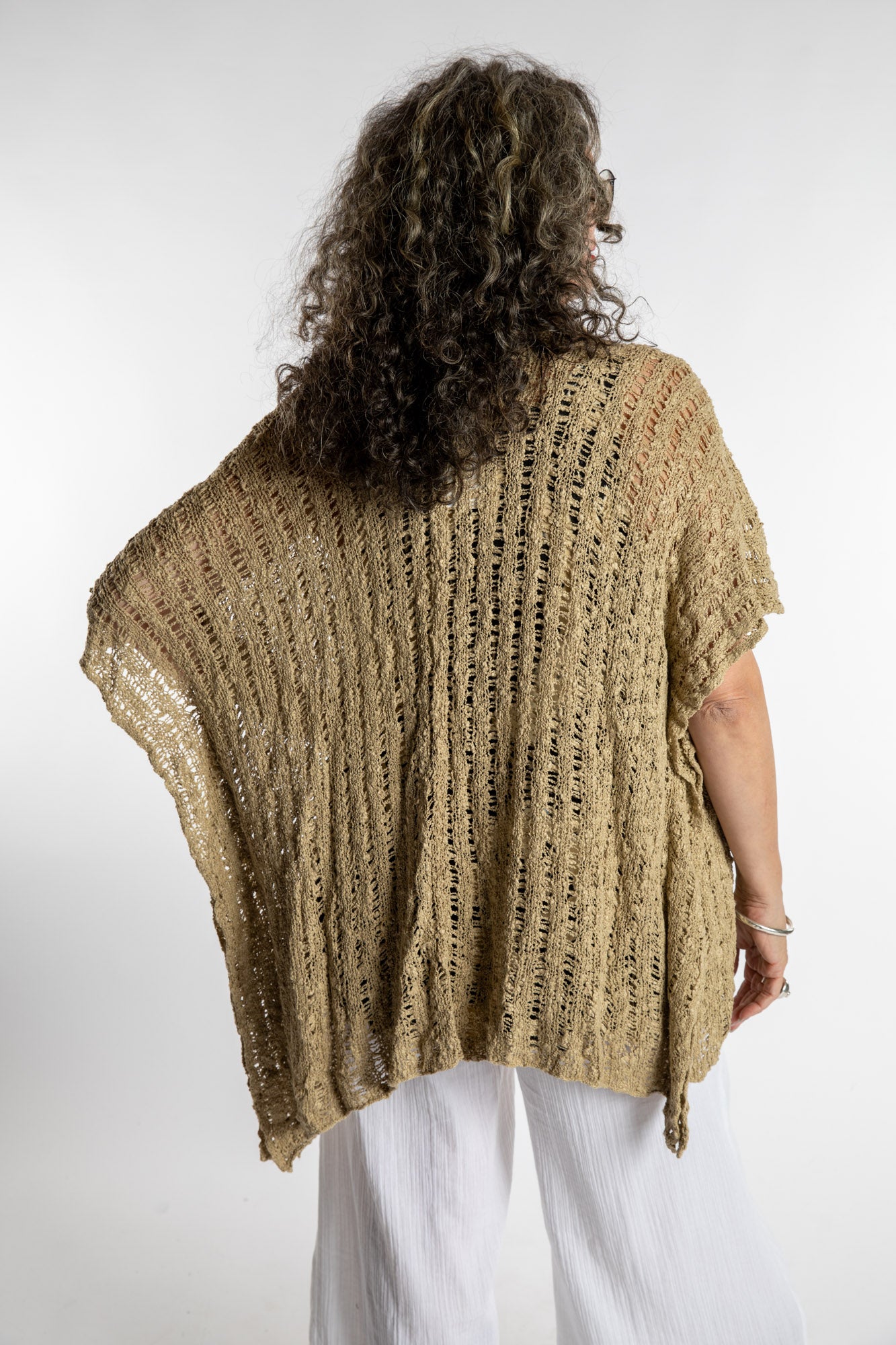Susan is wear the Cascade Loose Weave Cardigan in Tan