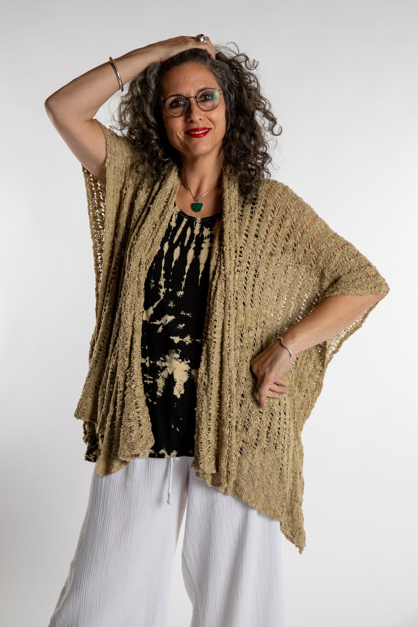 Susan is wear the Cascade Loose Weave Cardigan in Tan