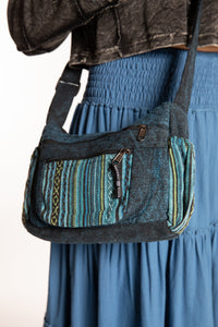 Sophie wearing blue Chroma Cargo Crossbody Bag with adjustable strap