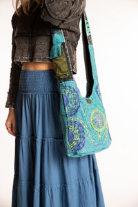 Sophie wearing the Cosmic Spiral Sling Bag in Blue