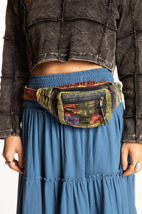 Sophie wearing colorful striped cotton fanny pack around waist 