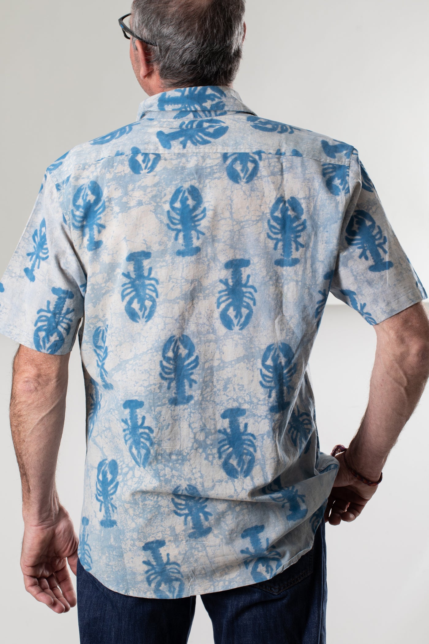 Ross is wearing size M lobster print button up in blue