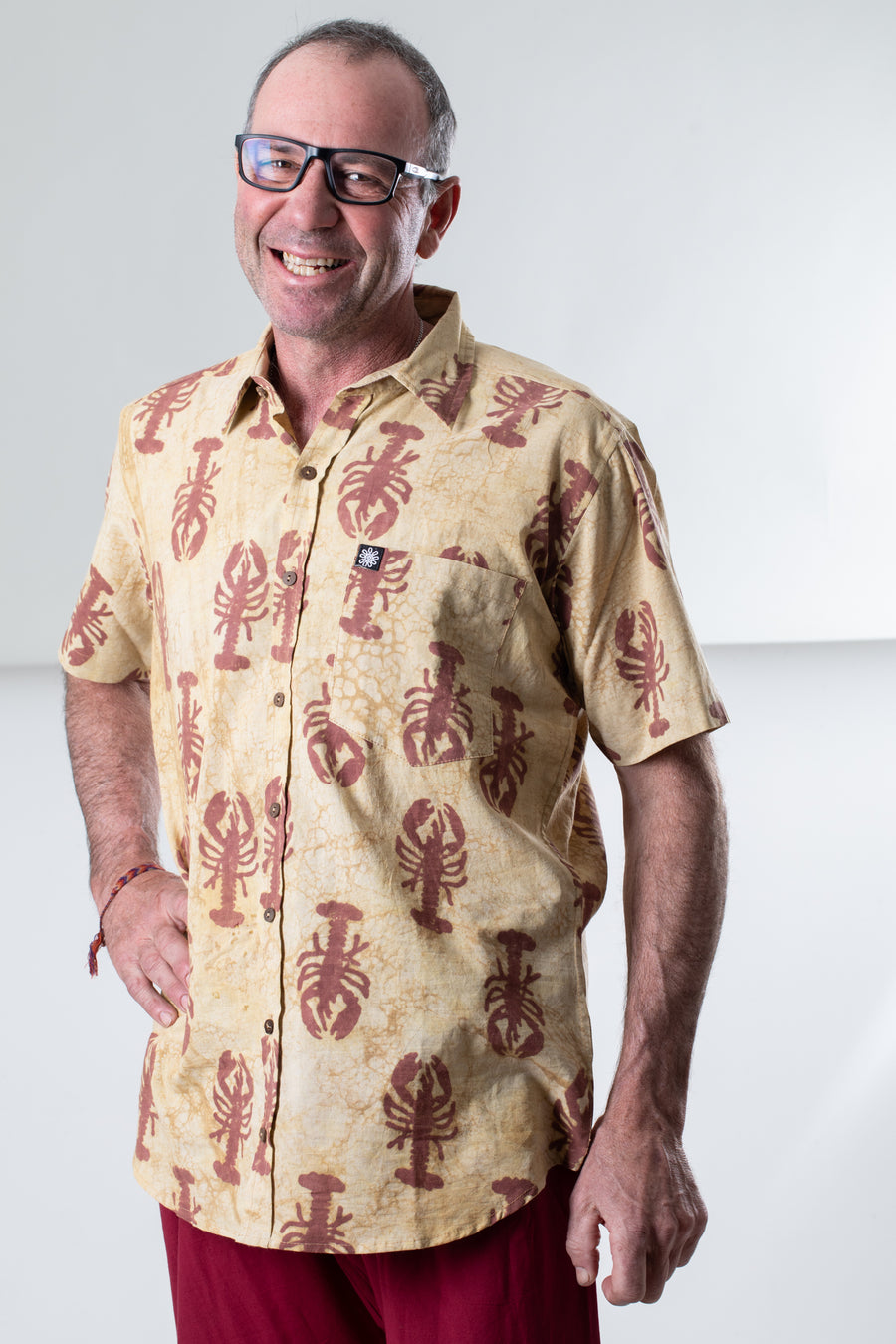 Ross is wearing size M lobster print button up in red
