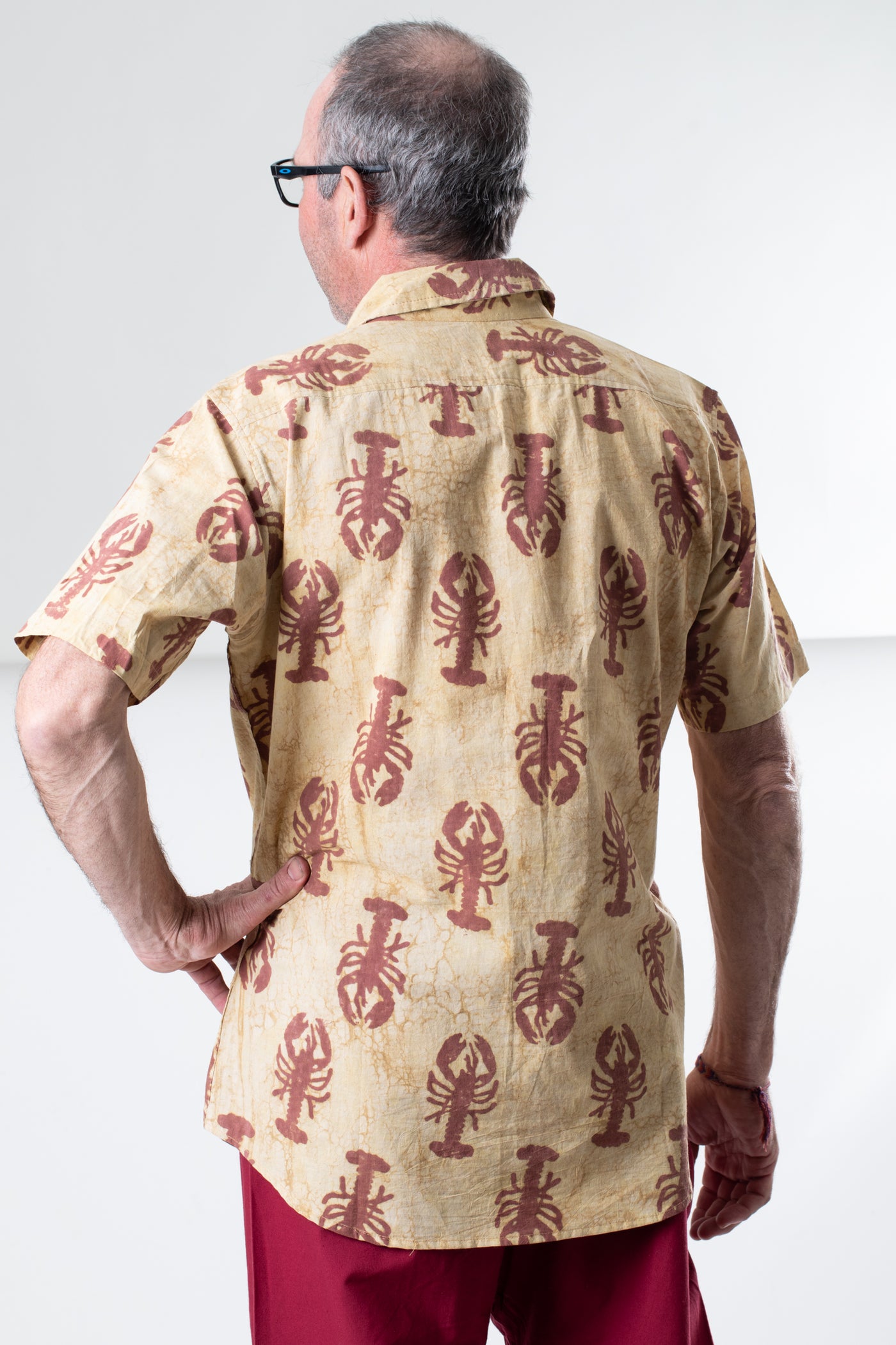 Ross is wearing size M lobster print button up in red