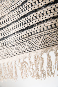 Block print woven rug in natural and black
