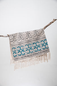 Block print woven rug in natural and teal