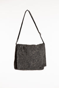 Black cotton messenger bag with foldover flap and adjustable shoulder strap