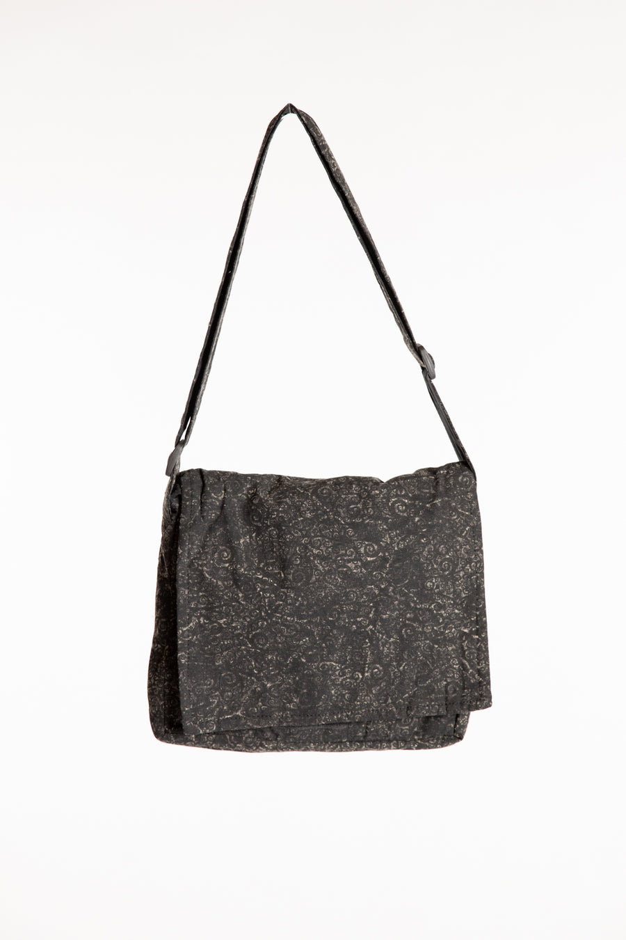 Black cotton messenger bag with foldover flap and adjustable shoulder strap