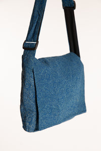 Blue ebb and flow messenger bag  with a black adjustable strap