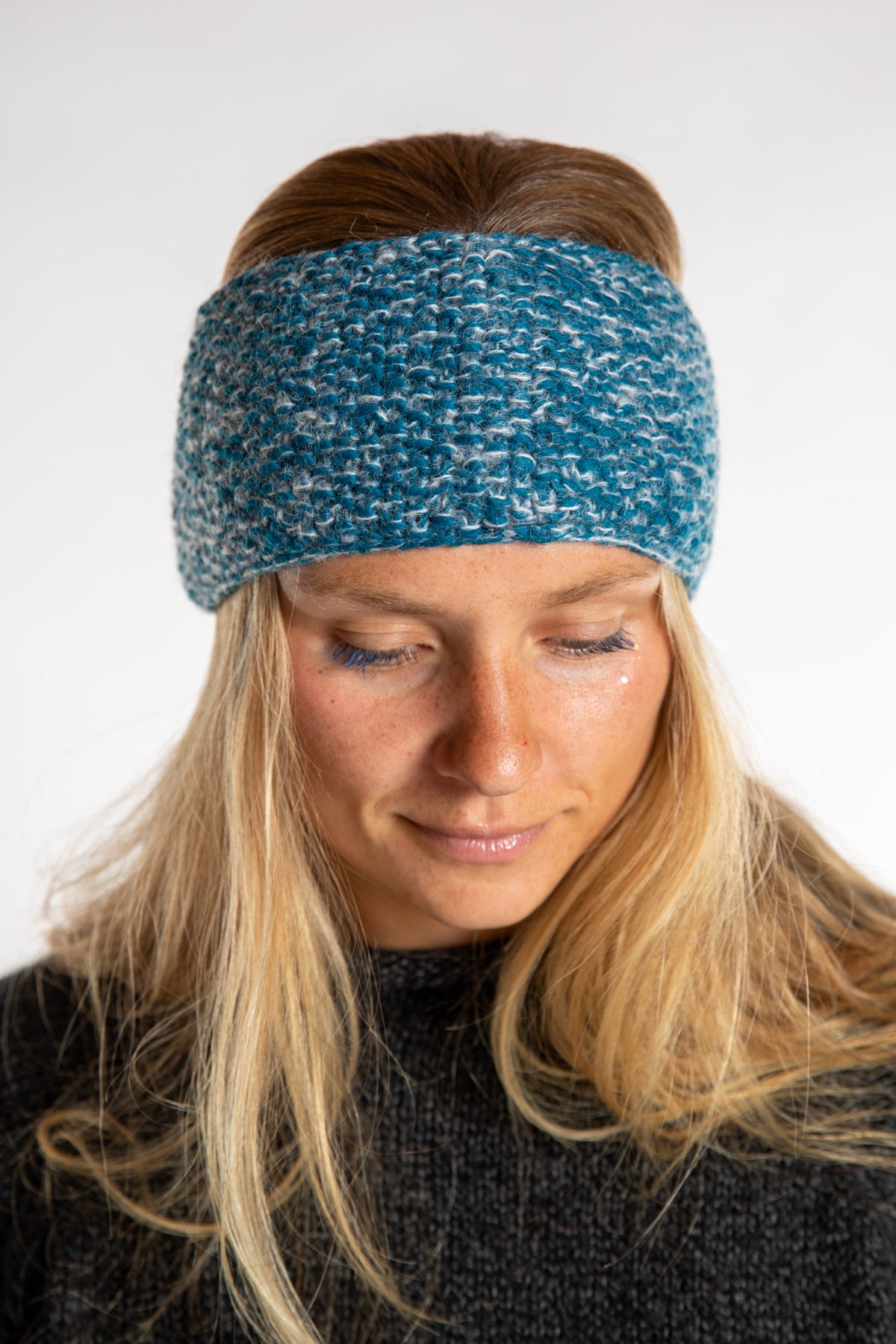 Sophie is wearing the Ember Plush Wool Headband in Aqua