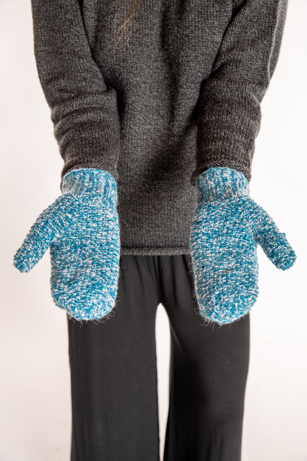 Sophie is wearing the Ember Plush Knit Wool Mittens in Aqua