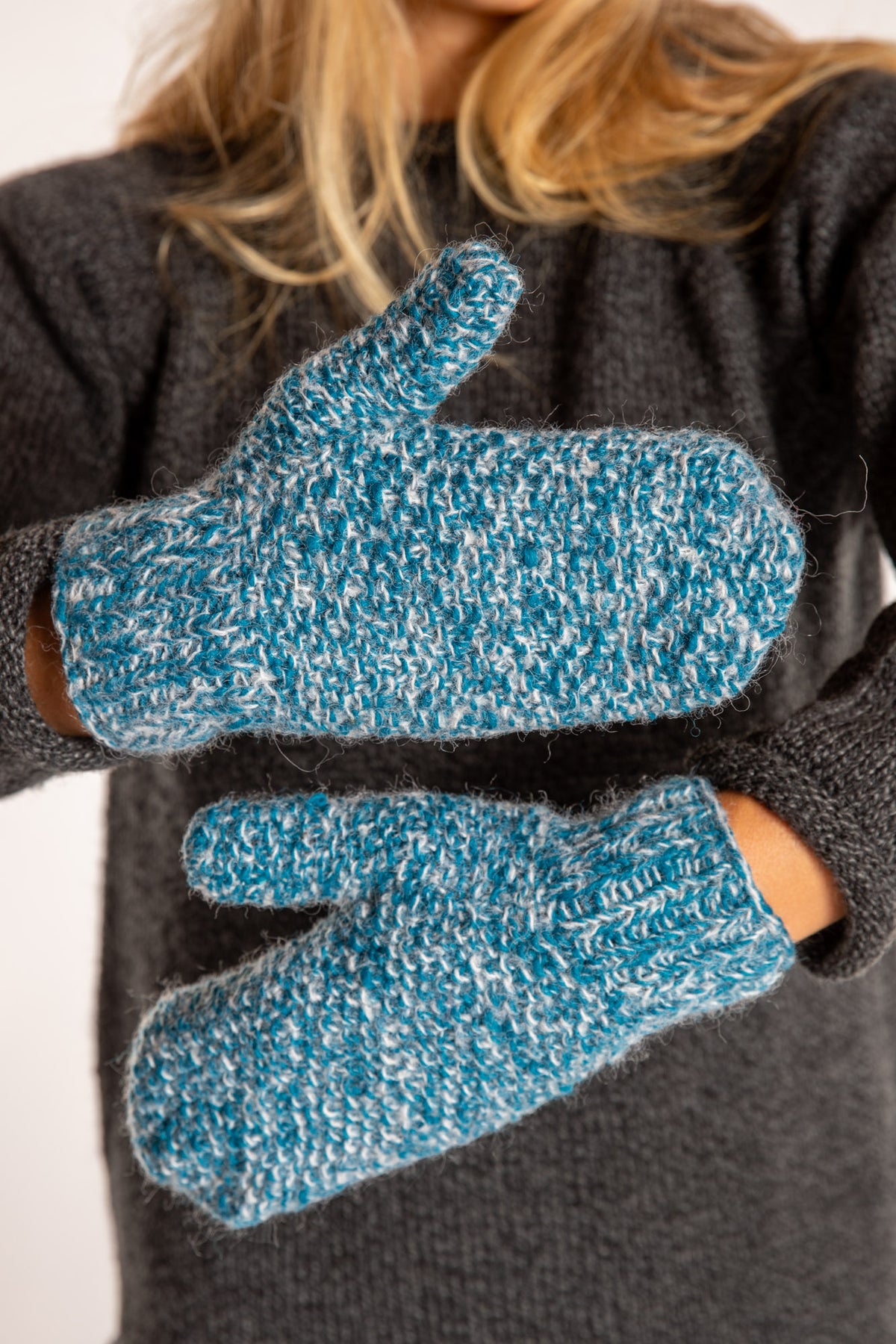 Sophie is wearing the Ember Plush Knit Wool Mittens in Aqua