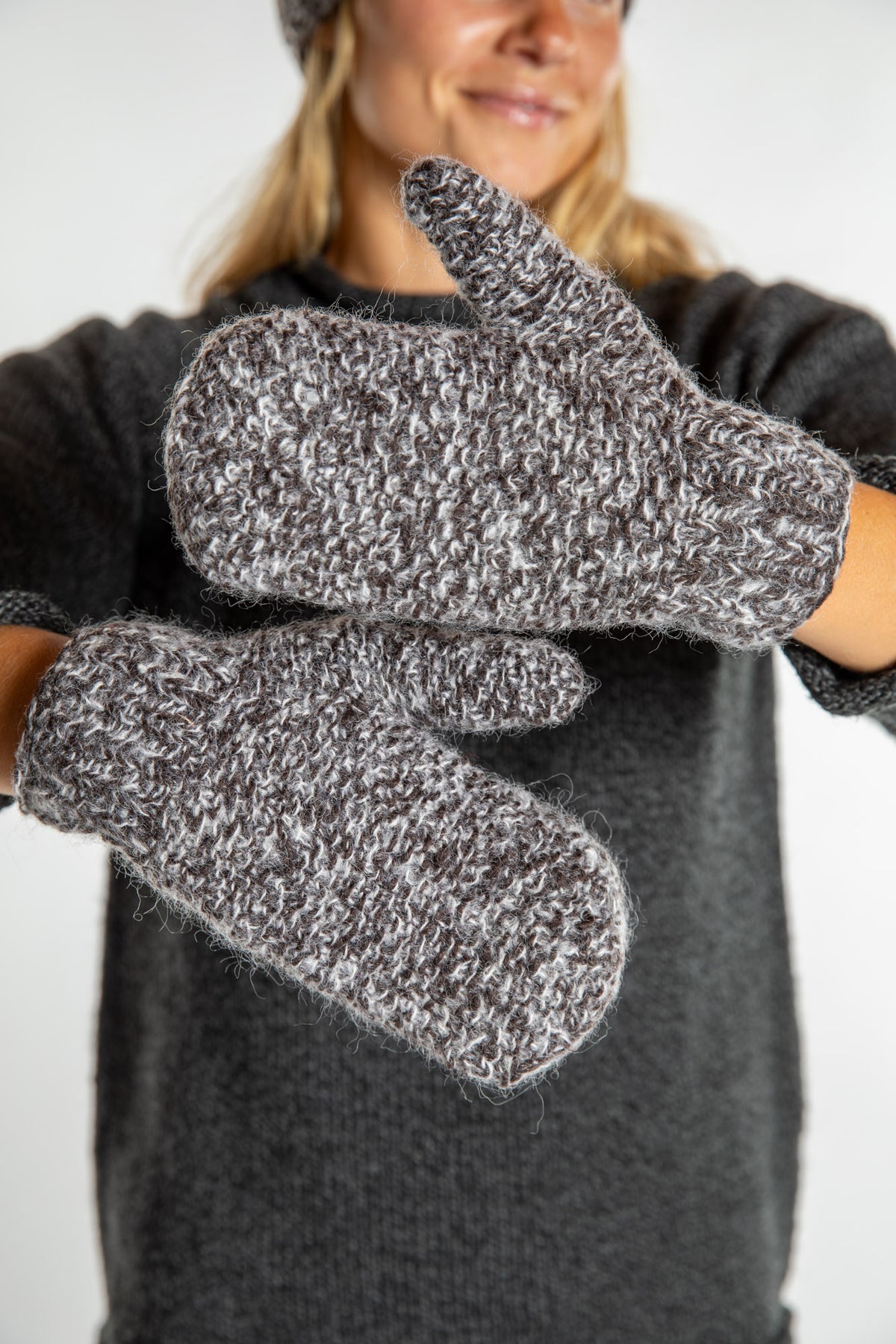 Sophie is wearing the Ember Plush Knit Wool Mittens in Brown