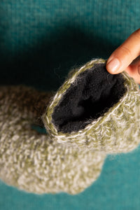 Sophie is wearing the Ember Plush Wool Headband in Green
