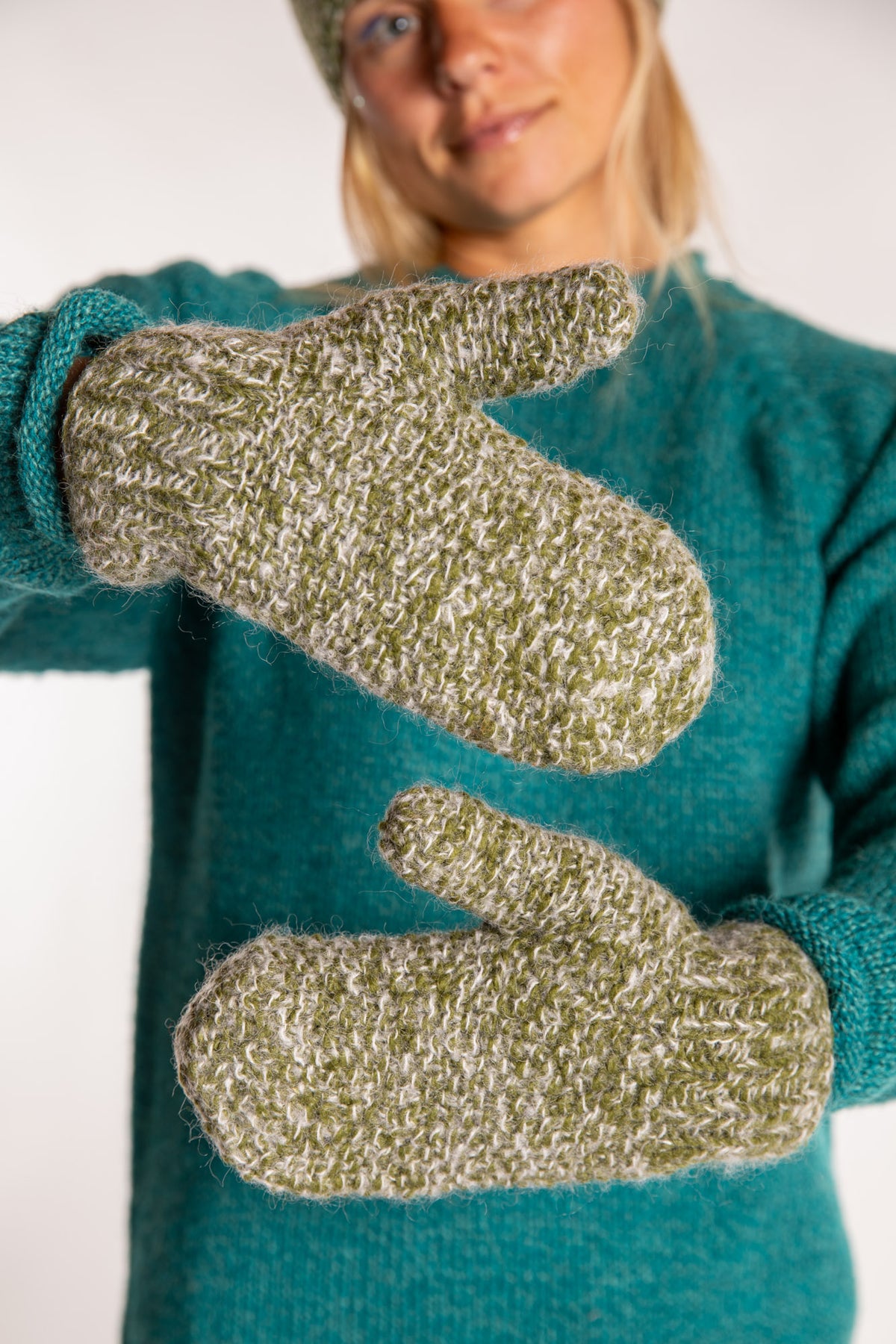 Sophie is wearing the Ember Plush Knit Wool Mittens in Green