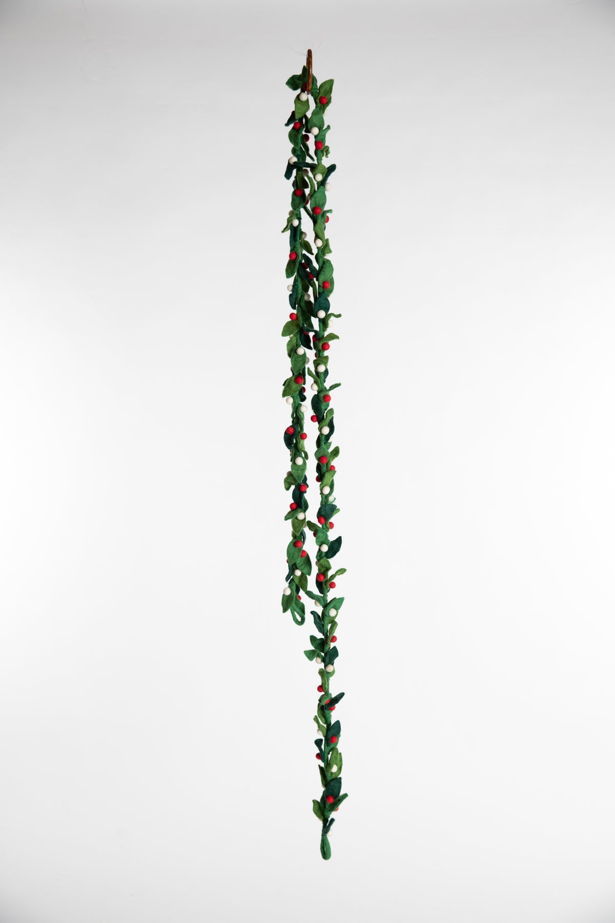 A felt garland of green leaves and red and white felt balls
