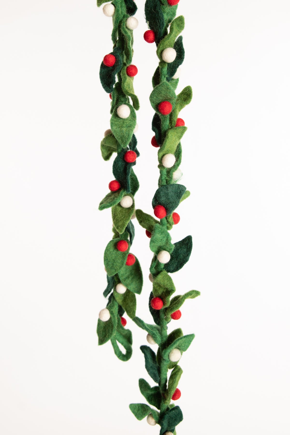 A felt garland of green leaves and red and white felt balls