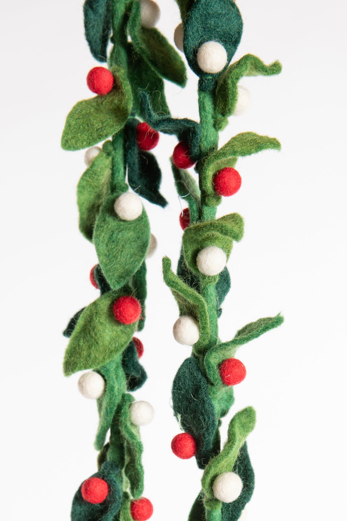 A felt garland of green leaves and red and white felt balls
