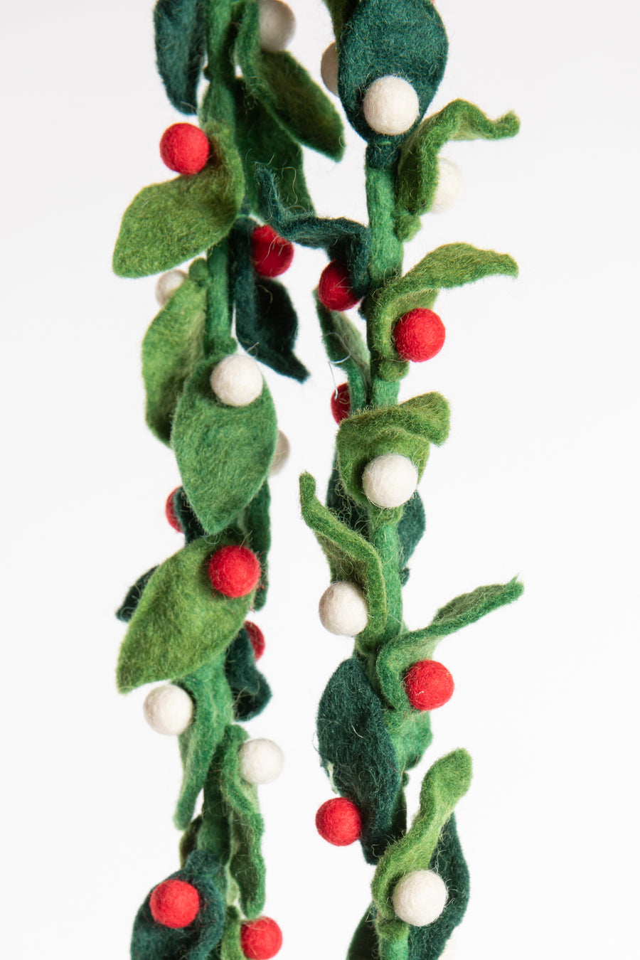 A felt garland of green leaves and red and white felt balls