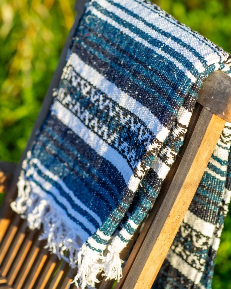 Blue falsa blanket hung over a chair back