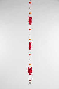 A beaded felt red lobster garland with felt balls 