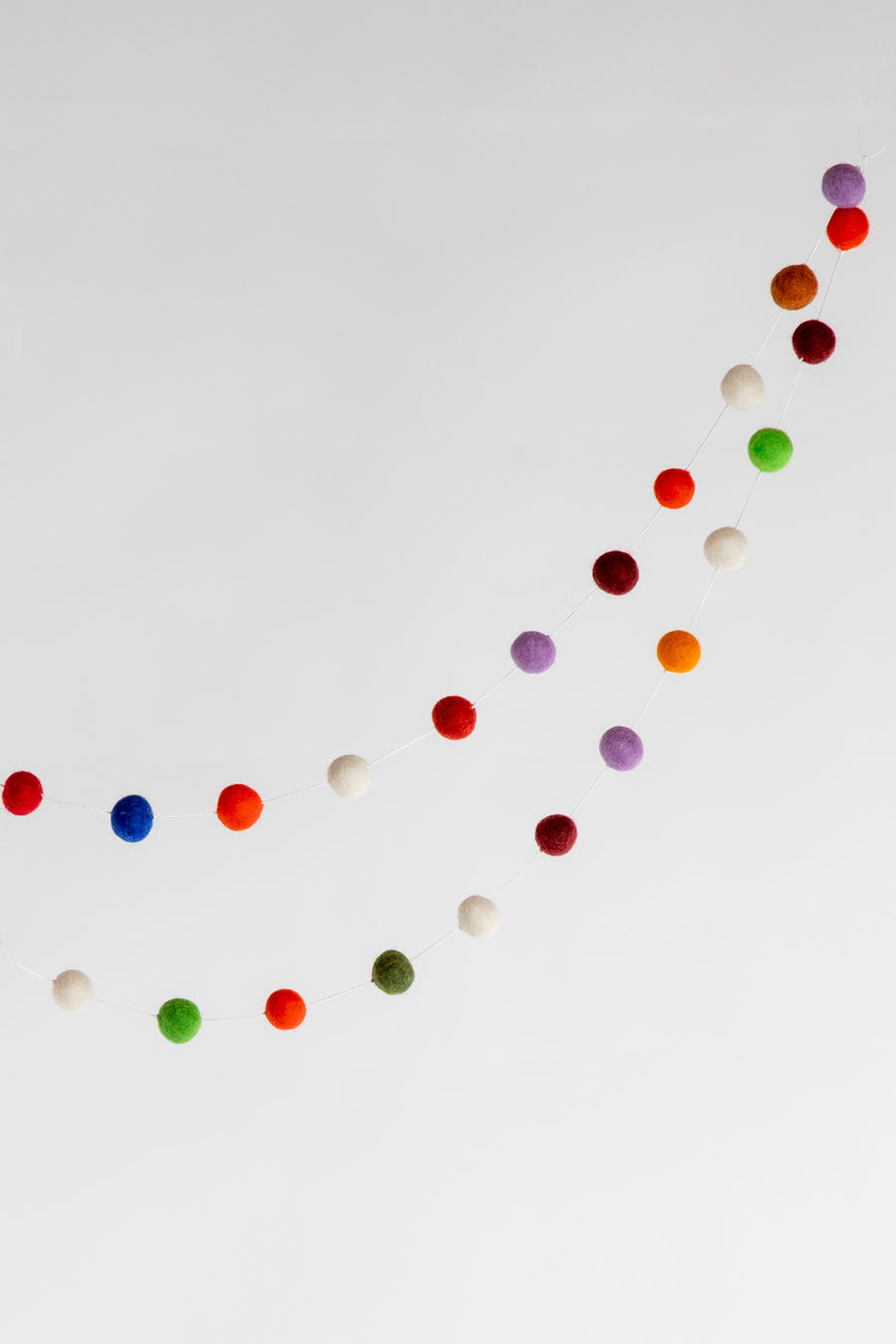 A long length of multicolor felt balls on a string 