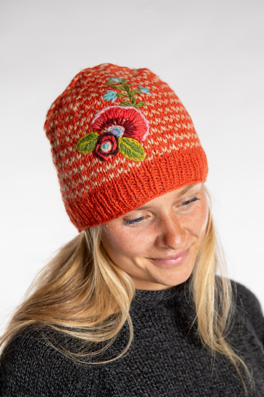 Sophie is wearing the Floral Embroidered Wool Beanie in Orange