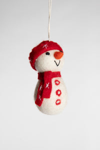 A felted white snowman ornament with a red hat, scarf, and buttons