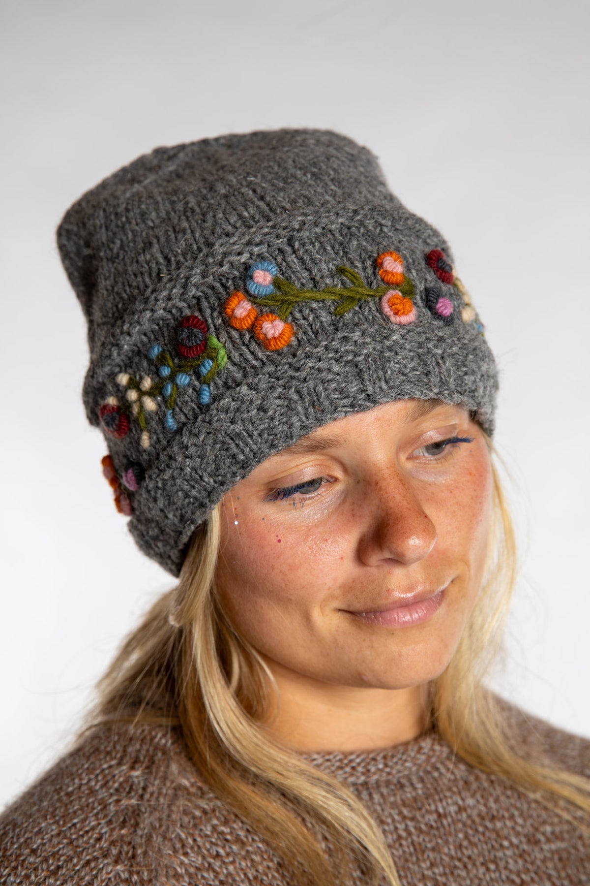 Sophie is wearing the Garden Embroidered Wool Beanie in Gray