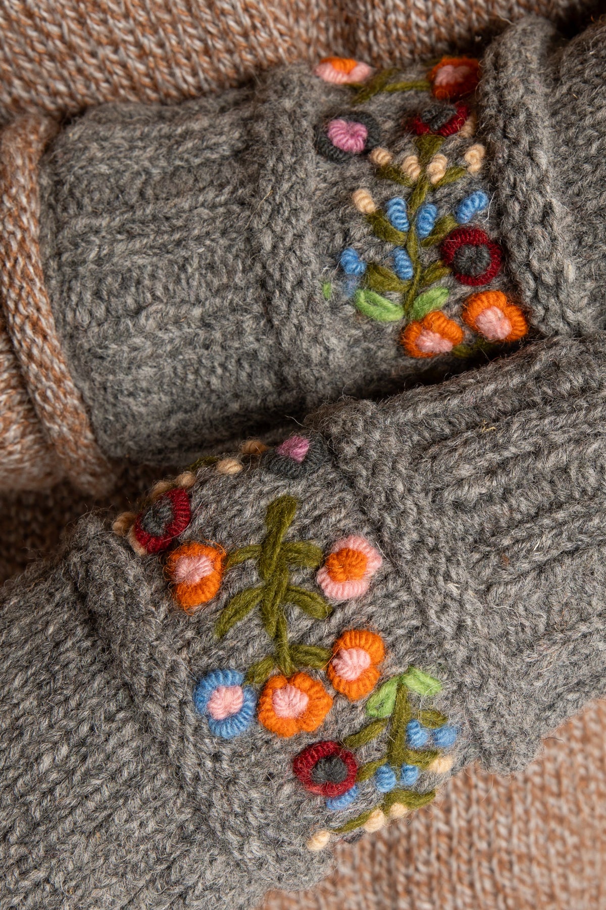 Sophie is wearing the Garden Embroidered Wool Fingerless Mittens in Gray