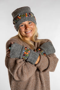 Sophie is wearing the Garden Embroidered Wool Fingerless Mittens in Gray
