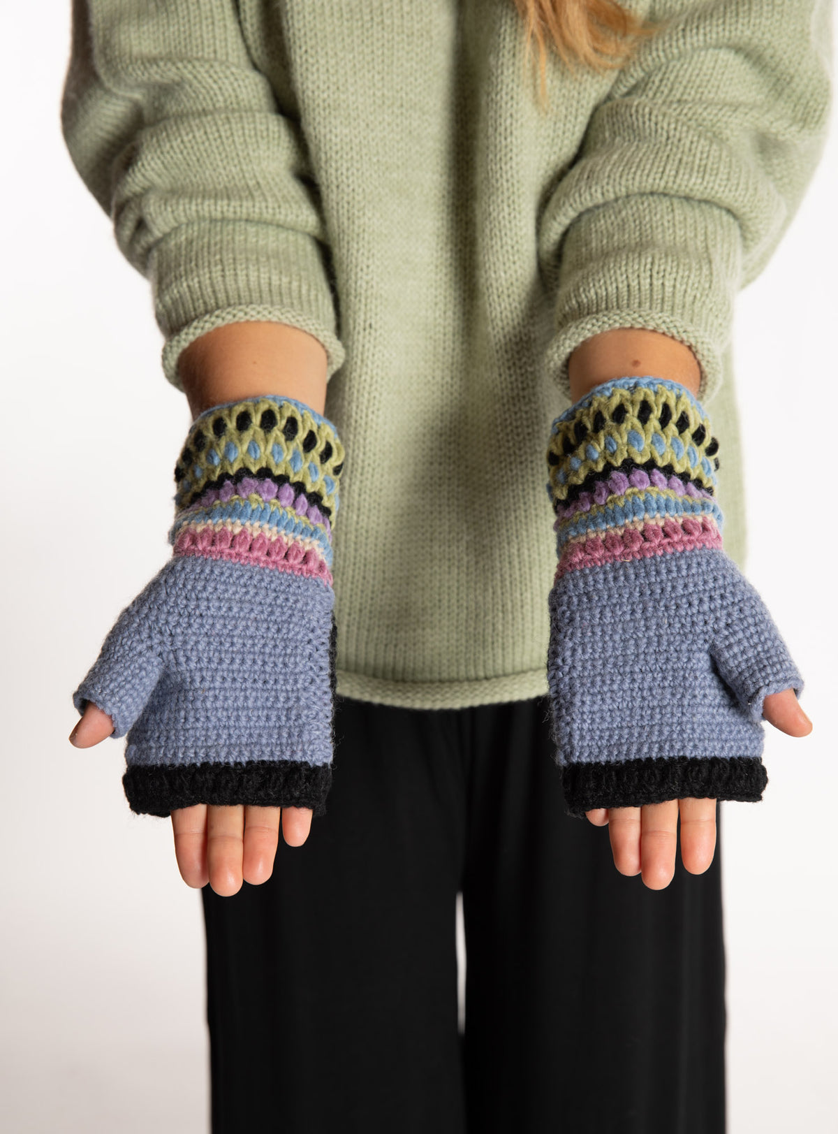 Sophie is wearing the Granny Square Wool Fingerless Mittens in Lavender