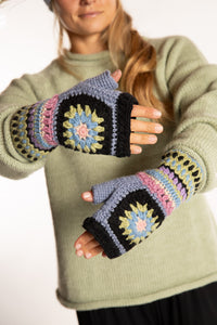 Sophie is wearing the Granny Square Wool Fingerless Mittens in Lavender