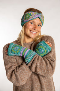 Sophie is wearing the Granny Square Wool Fingerless Mittens in Mint