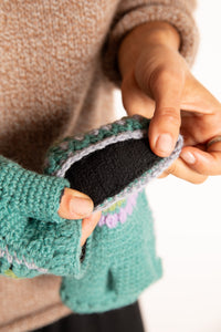 Sophie is wearing the Granny Square Wool Fingerless Mittens in Mint