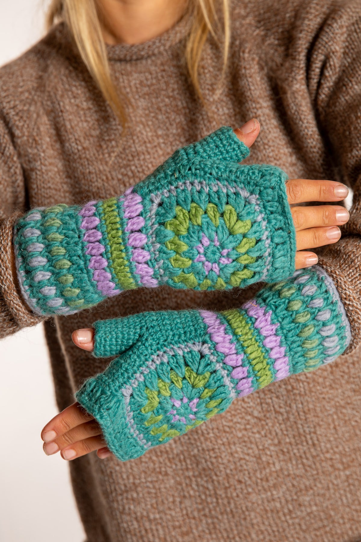 Sophie is wearing the Granny Square Wool Fingerless Mittens in Mint