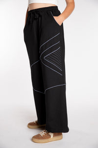 Emily is wearing the Black Himal Contrast Stitch Sweatpants in S/M