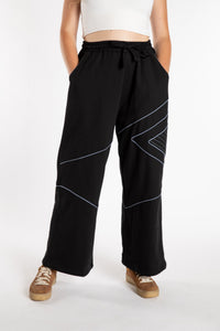 Emily is wearing the Black Himal Contrast Stitch Sweatpants in S/M