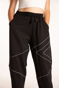 Emily is wearing the Black Himal Contrast Stitch Sweatpants in S/M