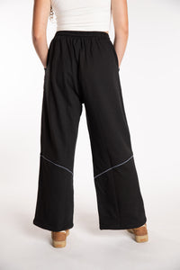 Emily is wearing the Black Himal Contrast Stitch Sweatpants in S/M