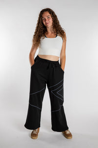 Emily is wearing the Black Himal Contrast Stitch Sweatpants in S/M